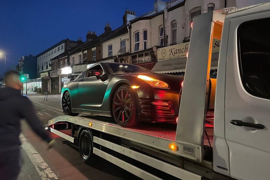 luxury car towing at night